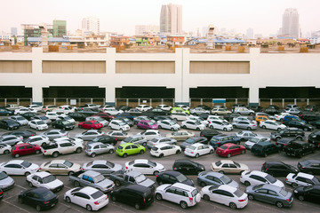 Open-air parking on the roof with cars. Big city. Skyscrapers on the background