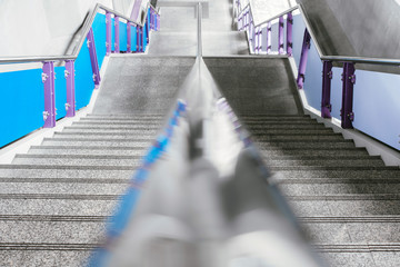 Empty stairs in the subway. Steel railing. The descent down. Deserted metro