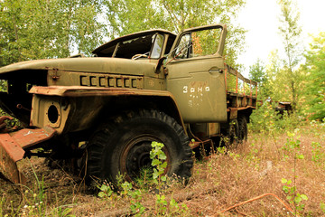 Old soviet military truck car trash in woods near Chernobyl in Prypyat