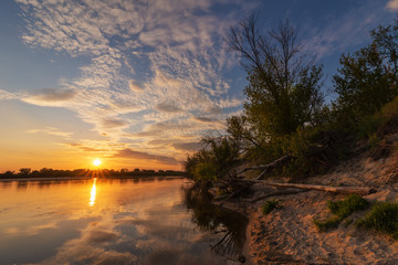 charming landscape on the river at sunset and night time