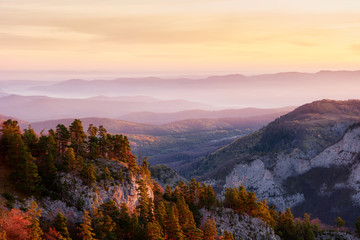Rocky mountain valley at sunrise with a cloudy sky and fir trees. Big Thach Natural Park. krasnodar region, Russia