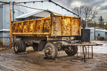 Obraz premium Old yellow truck semi-trailer at the warehouse of building materials