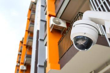 CCTV monitoring, security cameras. Backdrop with views of condominium or high building.
