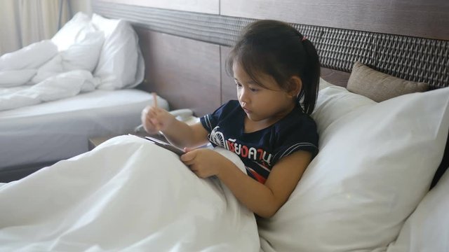 asian little girl drawing in bedroom