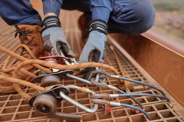Rope access miner level 3 technician wearing a safety glove conducting safety auditing checking...