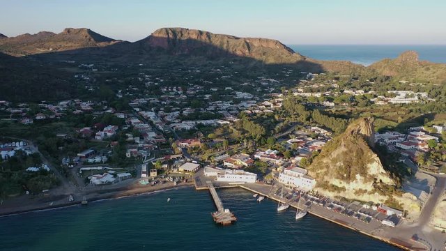 Beautiful panoramic aerial 4K video from flying drone on the rock  Vulcano island near Ship Port  a sunny morning. Aeolian Islands, Sicily, Italy (series)