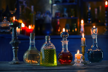 magic potions in bottles on wooden background