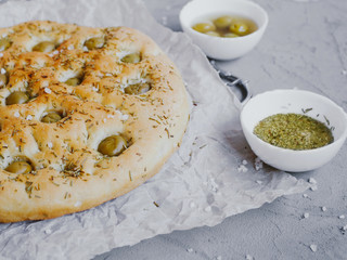 Traditional Italian focaccia bread with olives, rosemary, salt and olive oil. Homemade focaccia.