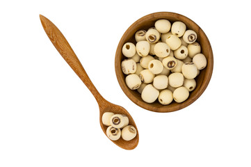 Dried lotus seeds in wooden bowl and wooden spoon on white background with clipping path. Nowadays lotus seed become popular healthy food and has highly beneficial for health.