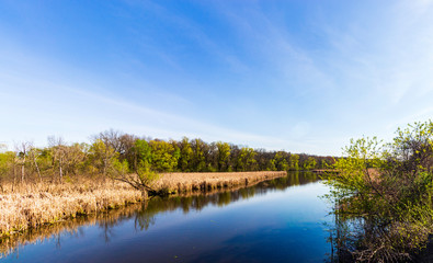 Fototapeta na wymiar Small Pond and a Walking Bridge on a Bike Trail in Southeastern Wisconsin