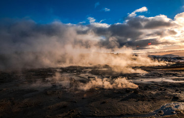 Fototapeta na wymiar Clouds of water vapor smelling sulfur sprouts in the Hverir volcanic area, Iceland