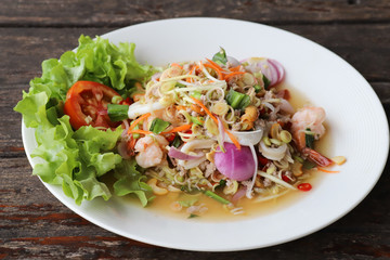 Spicy shrimp salad with fresh lemon grass, red onion, minced pork, squids and cashew nuts. Tasty Thai food