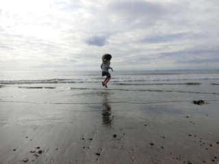 girl jumping on the beach
