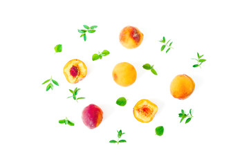 Ripe peaches with leaves isolated on white background. Summer fruits. Top view. Flat lay