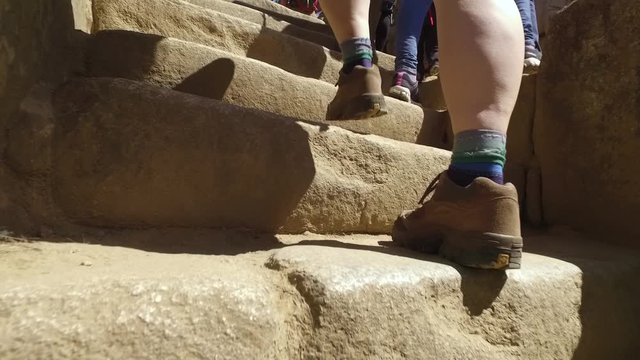 Hikers on stone stairs, Sacred plaza, Machu Picchu, Cusco, Peru