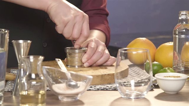 crushing flower using a muddler in the jar - panning