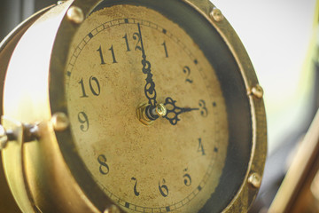 Close Up shot of an antique clock. Still life, time, old related, Dial of an old pendulum clock with beautiful figures, close up of golden clock.