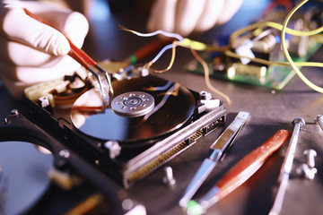 Naklejka premium Computer equipment. Repair of PC components. Hard drive for restoration in the workshop. Winchester virus recovery.