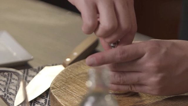 crushing into the jar by using a muddler - zoom