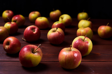 Fresh red-green apples on a wooden background.
