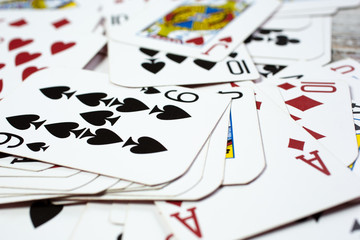 A closeup view of a pile of random playing cards.