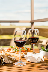 Red wine on a table with snacks