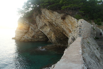 A small grotto in the middle of the sea overgrown with forest
