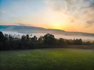 sunrise over foggy meadows