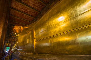 Giant sculpture of a reclining Buddha at the Buddhist temple Wat Pho. Bangkok, Thailand