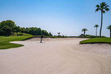 Golf Course with sand bunker. Golf course with a rich green turf beautiful scenery.