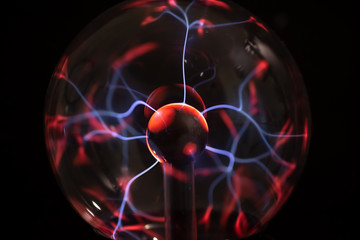 A view of the glowing electricity emitted from a plasma ball lamp, as a background.