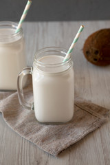 Coconut milk in glass jars, side view.