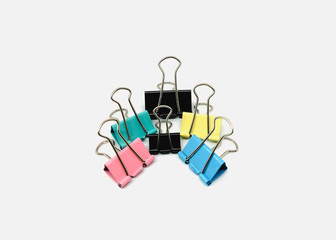 Six colorful binder clips on white background