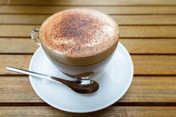 Cup of cappuccino coffee with chocolate sprinkles on top