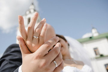 bride and groom holding hands together