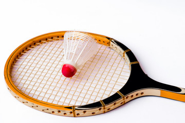 Close-up.Badminton concept.Racket and shuttlecock.Badminton racket and white shuttlecock with red cap on white background.