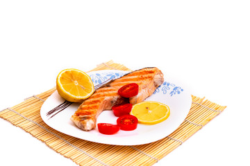 fried salmon with vegetables on a plate