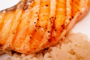 grilled salmon steak with tomatoes and rice, closeup