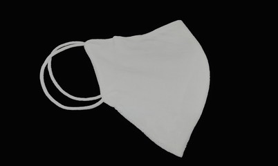 Side view of cloth mask isolated on a Black background, White medical mask isolated. Face mask protection against pollution and Covid-19 virus.
