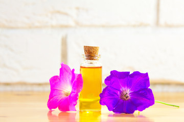 petunia essential oil in  beautiful bottle on table