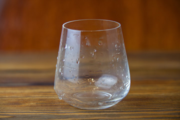 beautiful crystal drinking glass isolated on wooden background