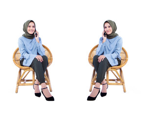 Obraz premium Beautiful Hijab woman sitting in a chair while calling with smiley expression, isolated on white background.