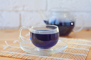 Crystal cup with green tea on table