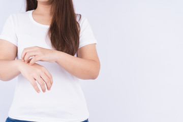 Female scratching her hand on white background with copy space. Medical, healthcare for advertising concept.