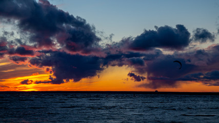 Sunset on the beach, waves, dramatic sky, dramatic clouds.