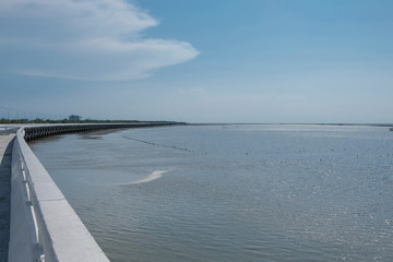 Long coastal winding bridge with blue sky background in Thailand - Dangerous curve road
