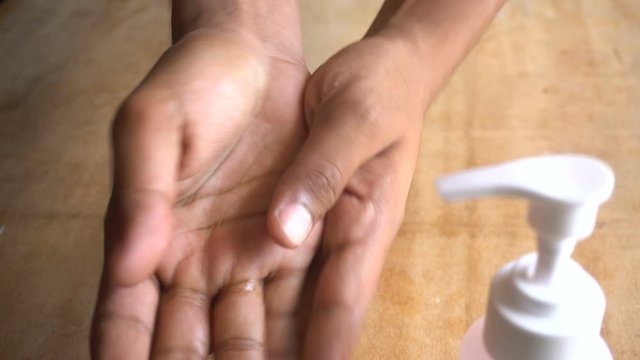 man applying hand sanitizer to hands