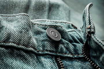 Denim blue jeans button and zip close-up. Casual jeans clothing in demin material, photographed in...