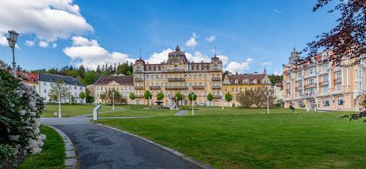 Fototapeta premium Goethe Square in small Czech spa town Marianske Lazne (Marienbad) - from the left museum, ruin of spa house Kavkaz and spa hotel