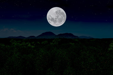 Fototapeta na wymiar Full moon over silhouette mountain at night.